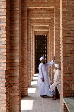 Men speak with each other at Bait Ur Rouf Mosque in Dhaka, Bangladesh April 23, 2016. Picture taken April 23, 2016. Aga Khan Award for Architecture/Handout via REUTERS