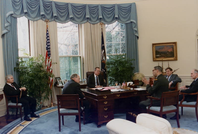 President Bush meets with members of his cabinet in the Oval Office.