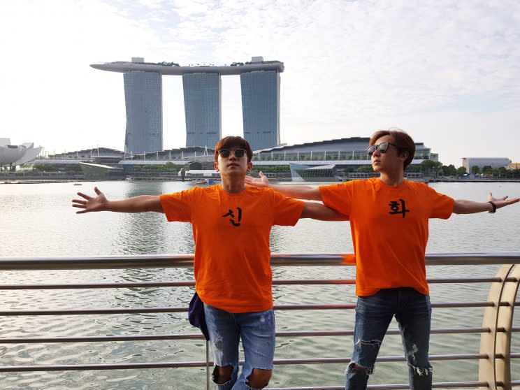 Shinhwa's Minwoo and Andy posing with Marina Bay Sands in the background (Photo: Shinhwa Company|Twitter)