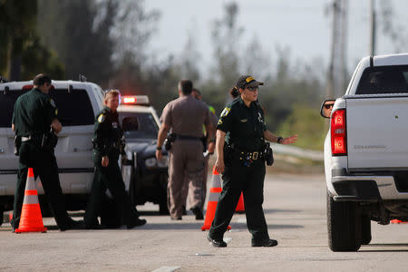 A local resident talks with a police officer as he is trying to enter the Florida Keys road after Hurricane Irma strikes Florida, in Homestead, Florida, U.S., September 11, 2017. REUTERS/Carlos Barria