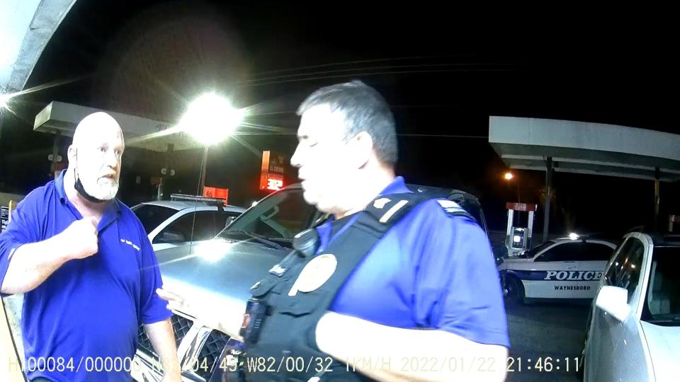 Sam Hendrix, left, talks with Sgt. Greg Stroud and Officer Ronald Bartlett (wearing body camera) before he was arrested for disorderly conduct outside a gas station in Waynesboro.