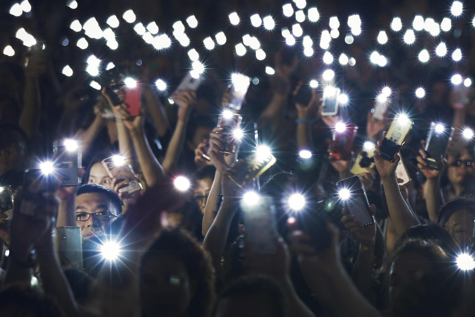 Attendees wave their lit mobile phones during a rally by mothers in support of student protesters in Hong Kong on Friday, Jan. 5, 2019. Student unions from two Hong Kong universities said Friday that they have turned down invitations from city leader Carrie Lam for talks about the recent unrest over her proposal to allow the extradition of suspects to mainland China. (AP Photo/Andy Wong)