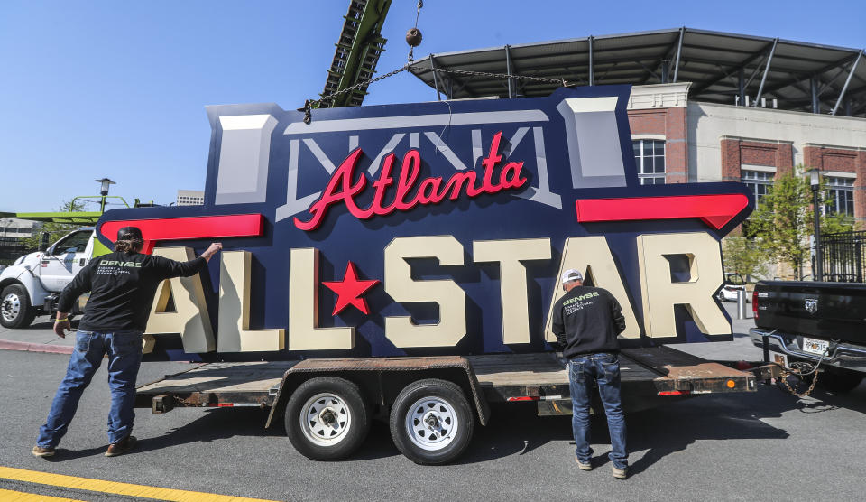 Workers load an All-Star sign onto a trailer after it was removed from Truist Park in Atlanta, Tuesday, April 6, 2021. Major League Baseball plans to relocate the All-Star Game to Coors Field in Denver after pulling this year's Midsummer Classic from Atlanta over objections to sweeping changes to Georgia's voting laws, according to a person familiar with the decision. The person spoke to The Associated Press on condition of anonymity Monday night, April 5, 2021, because MLB hadn’t announced the move yet. (John Spink/Atlanta Journal-Constitution via AP)