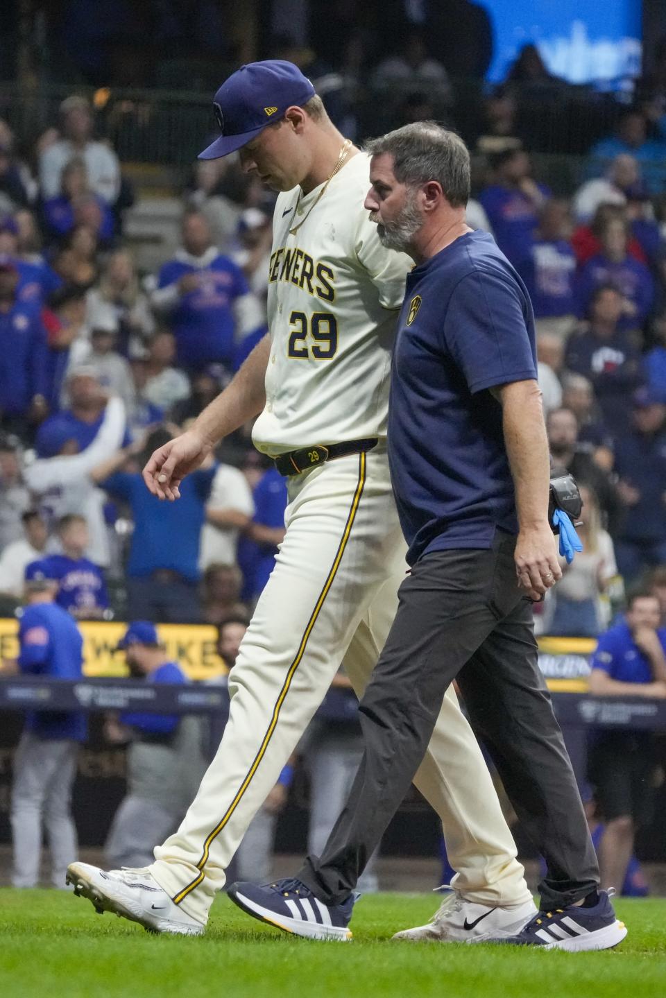 Milwaukee Brewers pitcher Trevor Megill leaves the game after being hit with a line drive off the bat of Chicago Cubs' Mike Tauchman during the 10th inning of a baseball game Tuesday, May 28, 2024, in Milwaukee. (AP Photo/Morry Gash)