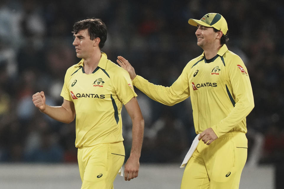 Australia's Pat Cummins, left, celebrates with teammate after the dismissal of India's captain Rohit Sharma during the third T20 cricket match between India and Australia, in Hyderabad, India, Sunday, Sept. 25, 2022. (AP Photo/Mahesh Kumar A)