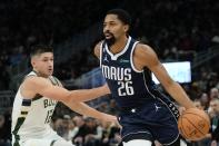 Dallas Mavericks' Spencer Dinwiddie drives past Milwaukee Bucks' Grayson Allen during the first half of an NBA basketball game Sunday, Nov. 27, 2022, in Milwaukee. (AP Photo/Morry Gash)