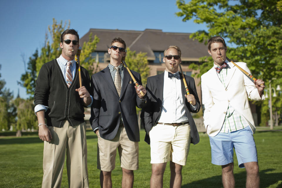 men smoking cigars and holding croquet mallets