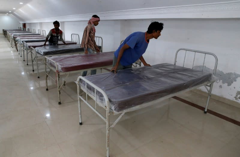 FILE PHOTO: Workers prepare beds to set up a quarantine facility amid concerns about the spread of coronavirus disease (COVID-19) in Howrah on the outskirts of Kolkata