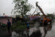 MUMBAI, INDIA - JUNE 03: Fishermen relocate a boat as part of precautions against Cyclone Nisarga in Mumbai, India on June 03, 2020. A storm in the Arabian Sea off India's west coast intensified into a severe cyclone on Wednesday, gathering speed as it barreled toward India's financial capital of Mumbai. Nisarga was forecast to drop heavy rains and winds gusting up to 120 kilometers (75 miles) per hour when it makes landfall Wednesday afternoon as a category 4 cyclone near the coastal city of Alibagh, about 98 kilometers (60 miles) south of Mumbai, India's Meteorological Department said. (Photo by Imtiyaz Shaikh/Anadolu Agency via Getty Images)