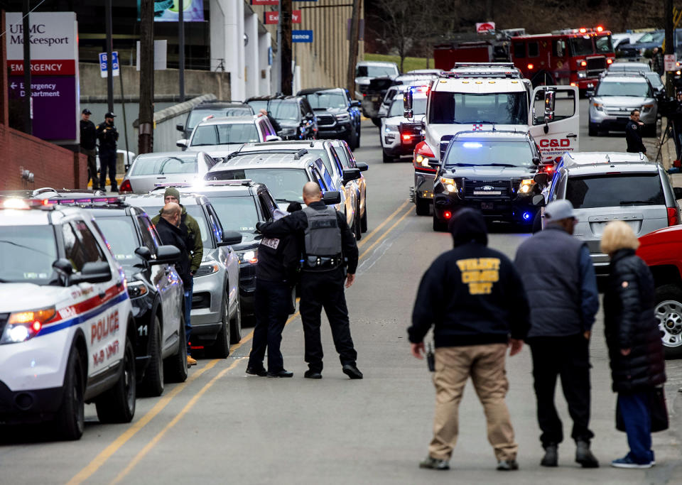 Police officers share a moment as they prepare to line up for a procession which includes the body of a fallen McKeesport police officer, outside of UPMC McKeesport Hospital on Monday, Feb. 6, 2023, McKeesport, Pa. One McKeesport police officer was killed, and another was wounded Monday afternoon after responding to a domestic disturbance call where they were fired upon by a man authorities said was having a "mental health crisis. (Arturo Fernandez/Pittsburgh Post-Gazette via AP)