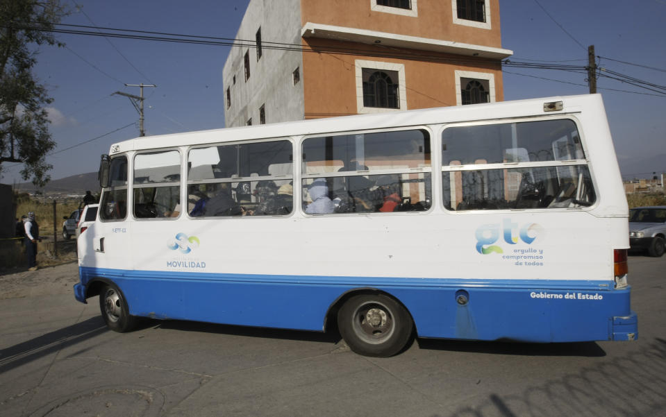 Members of a family search group enter the site on a bus where mass graves were found in Salvatierra, Guanajuato state, Mexico, Thursday, Oct. 29, 2020. A Mexican search group said Wednesday it has found 59 bodies in a series of clandestine burial pits in the north-central state of Guanajuato, and that more could still be excavated. (AP Photo/Mario Armas)