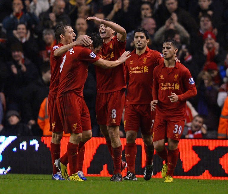 Liverpool's midfielder Steven Gerrard (C) celebrates with Stewart Downing (2nd L) and teammates after scoring their second goal during the English Premier League football match against Fulham at Anfield in Liverpool, north-west England on December 22, 2012. Downing finally ended his Premier League goal drought as the Reds swept to a 4-0 victory over Fulham at Anfield