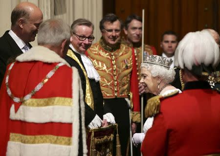 Britain's Queen Elizabeth II speaks to Leader of the House of Commons Chris Grayling (L) and Justice Secretary Michael Gove (2nd L) ahead of the State Opening of Parliament, in the House of Lords at the Palace of Westminster in London, Britain, May 18, 2016. REUTERS/Yui Mok/Pool