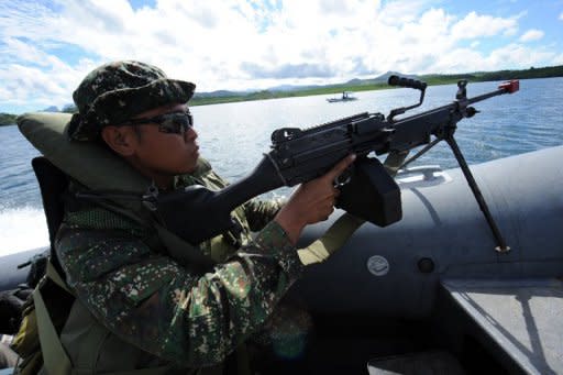 Philippine marines patrol along Ulugan Bay, facing the South China Sea. The United States and the Philippines called for freedom of navigation in the tense South China Sea as the White House offered a robust show of support for President Benigno Aquino