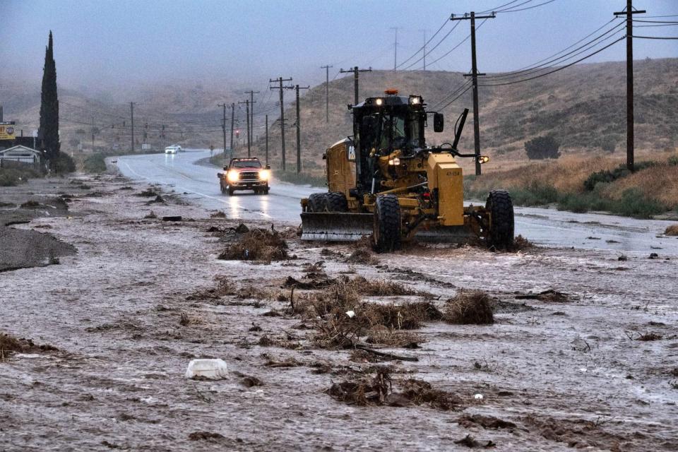 PHOTO: A plow clears debris along a flooded Sierra Highway in Palmdale, Calif., as Tropical Storm Hilary moves through the area on Sunday, Aug. 20, 2023. (Richard Vogel/AP)