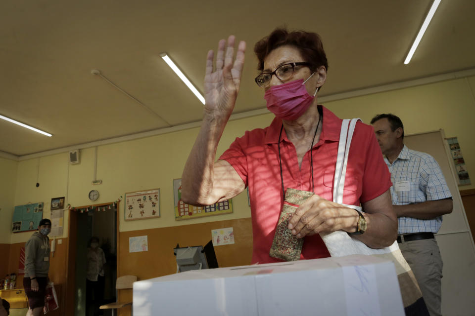 A woman reacts after casting her vote in Sofia, Sunday, July 11, 2021. Bulgarians are voting in a snap poll on Sunday after a previous election in April produced a fragmented parliament that failed to form a viable coalition government. (AP Photo/Valentina Petrova)