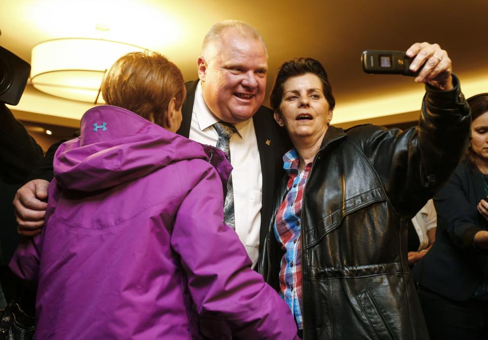 Toronto Mayor Rob Ford (C) takes a selfie with supporters at his campaign launch party in Toronto, April 17, 2014. The Toronto municipal election is set for October 2014.