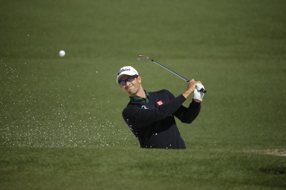 Adam Scott, of Australia, hits out of a bunker on the second fairway during the first round of the Masters golf tournament Thursday, April 10, 2014, in Augusta, Ga. (AP Photo/Chris Carlson)