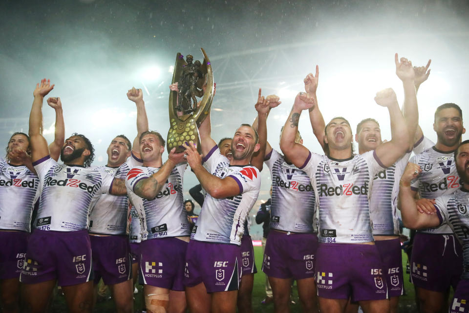 SYDNEY, AUSTRALIA - OCTOBER 25: Cameron Munster of the Storm and Cameron Smith of the Storm celebrate with team mates after winning the 2020 NRL Grand Final match between the Penrith Panthers and the Melbourne Storm at ANZ Stadium on October 25, 2020 in Sydney, Australia. (Photo by Cameron Spencer/Getty Images)