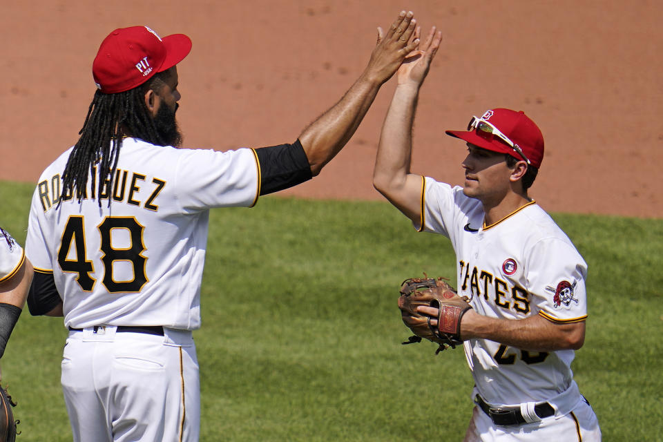 Pittsburgh Pirates relief pitcher Richard Rodriguez (48) celebrates with Adam Frazier after getting the final out of a baseball game against the Milwaukee Brewers in Pittsburgh, Sunday, July 4, 2021. (AP Photo/Gene J. Puskar)