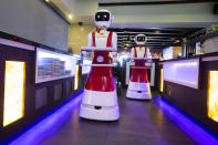 Robots, for serving purposes or for dirty dishes collection, advance as part of a tryout of measures to respect social distancing and help curb the spread of the COVID-19 coronavirus, at the Hu family's Royal Palace restaurant in Renesse, south-western Netherlands, Wednesday, May 27, 2020. (AP Photo/Peter Dejong)