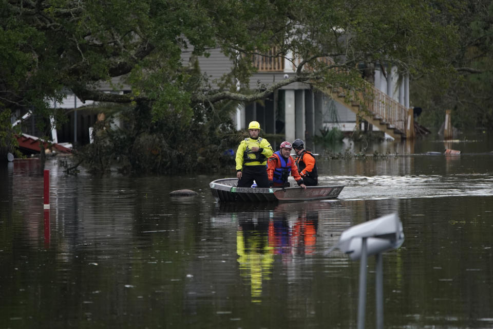 Animal rescue drive a boat down a flooded street in the aftermath of Hurricane Ida, Wednesday, Sept. 1, 2021, in Lafitte, La. Following Hurricane Ida, mutual aid networks sprang into action to supplement the more established relief services from federal and local governments, and charities. (AP Photo/John Locher)