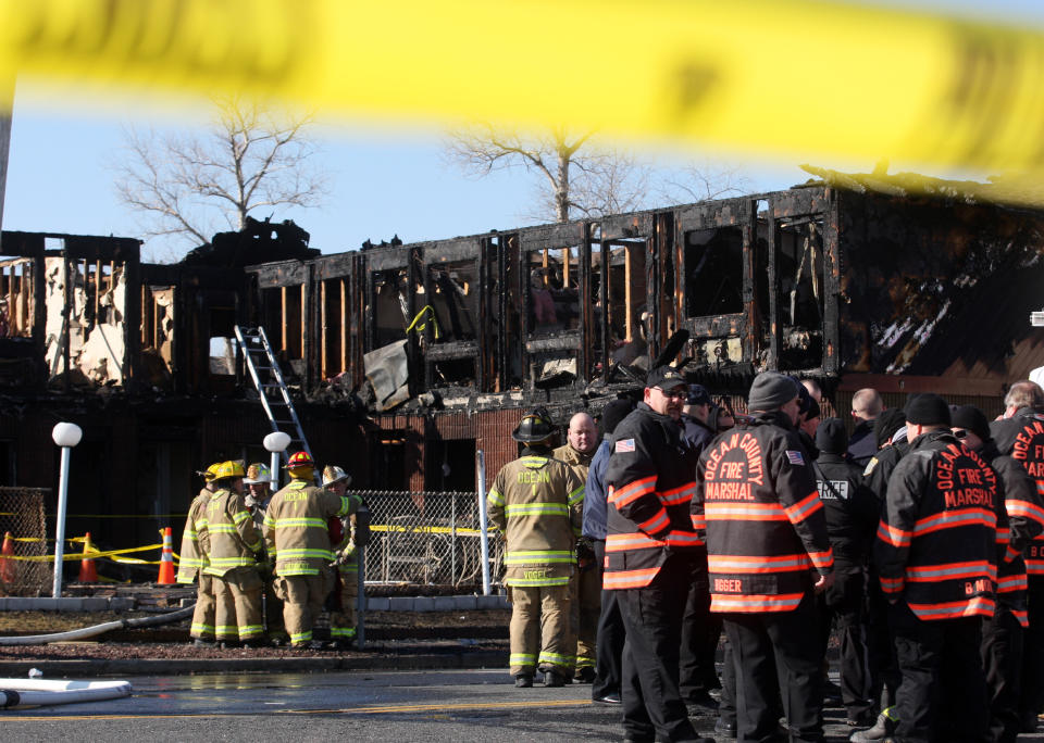 Firefighters investigate an early morning fire at the Mariner's Cove Hotel in Point Pleasant Beach, N.J. on Friday, March 21, 2014. (AP Photo/David Gard)