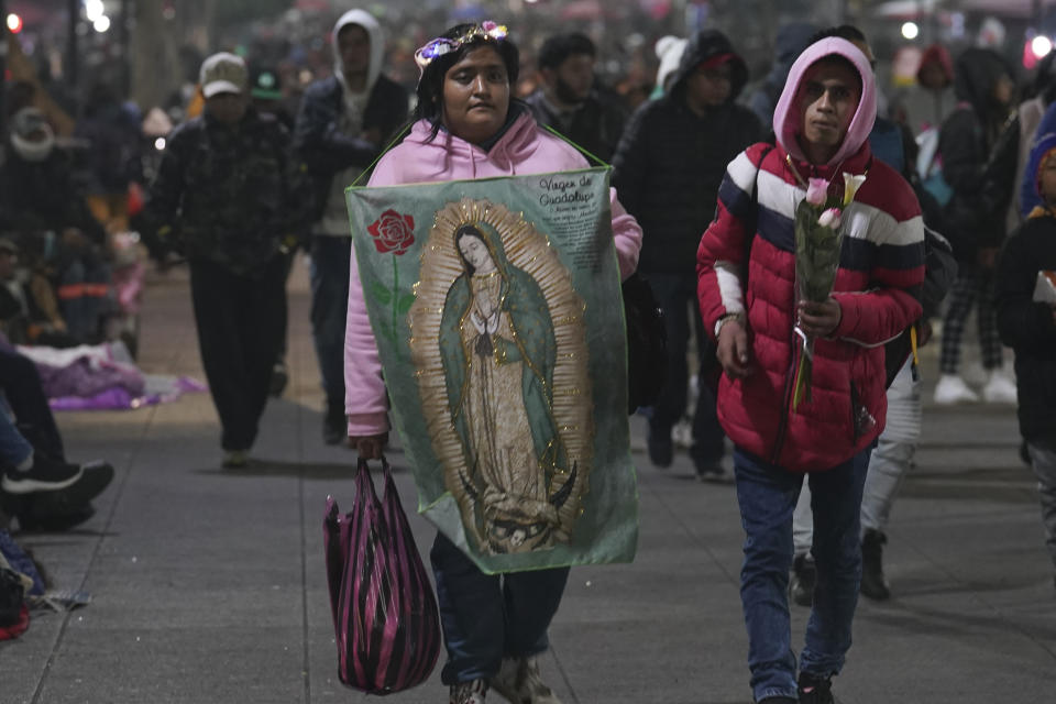 Pilgrims walk to the Basilica of Guadalupe on her feast day in Mexico City, early Tuesday, Dec. 12, 2023. Devotees of Our Lady of Guadalupe gather for one of the world's largest religious pilgrimages on the anniversary of one of several apparitions of the Virgin Mary witnessed by an Indigenous Mexican man named Juan Diego in 1531. (AP Photo/Marco Ugarte)