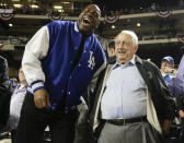 Former NBA player Magic Johnson, left, laughs with Tommy Lasorda between innings of baseball's Game 3 of the National League Division Series between the New York Mets and the Los Angeles Dodgers, Monday, Oct. 12, 2015, in New York. (AP Photo/Julie Jacobson)