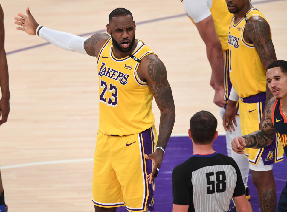 May 19, 2021; Los Angeles, California, USA;    Los Angeles Lakers forward LeBron James (23) and Golden State Warriors forward Juan Toscano-Anderson (95) plead their case to referee Josh Tiven (58) in the first half at Staples Center. Mandatory Credit: Jayne Kamin-Oncea-USA TODAY Sports