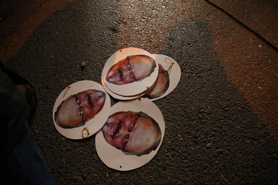 Placards with photos of killed Saudi journalist Jamal Khashoggi, are pictured on the ground during a candlelight vigil outside Saudi Arabia's consulate in Istanbul, Thursday, Oct. 25, 2018. A group of Arab and international public, political and media figures are establishing a global association called "Khashoggi's Friends Around the World"; "to achieve justice for the freedom martyr".(AP Photo/Lefteris Pitarakis)