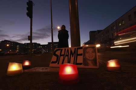 A woman holds a candlelit vigil outside University Hospital Galway in Galway, Ireland November 15, 2012. Ireland's government on Thursday pledged to clarify its abortion laws after a woman, who was denied a termination, died from septicaemia in an Irish hospital. REUTERS/Cathal McNaughton