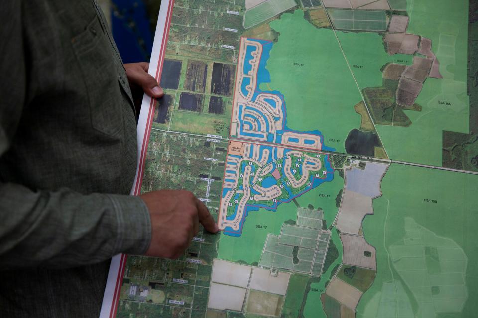 Christian Spilker, vice president of land management for Collier Enterprises, points to a map of the proposed Rivergrass Village near Oil Well Road on Monday, January 20, 2020.