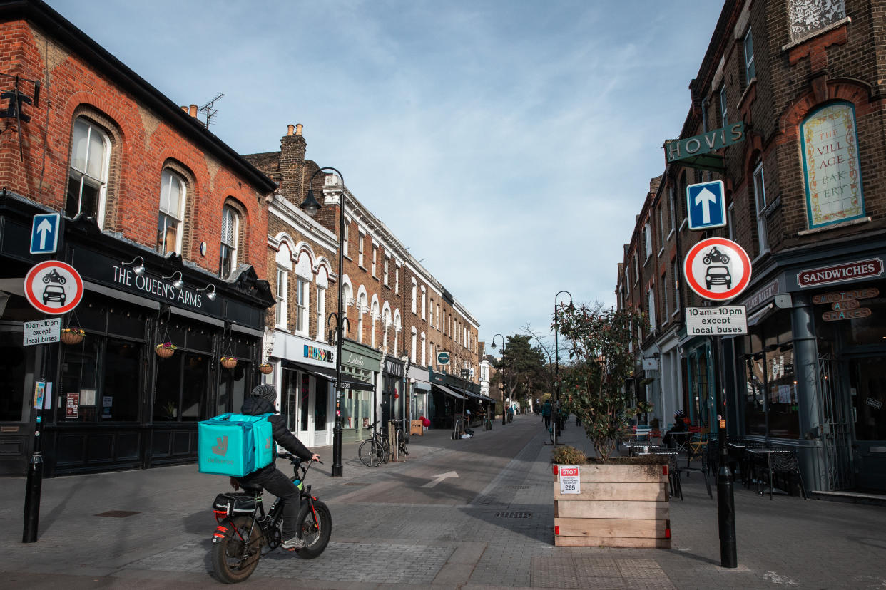 A food courier is pictured passing along Orford Road in Walthamstow Village