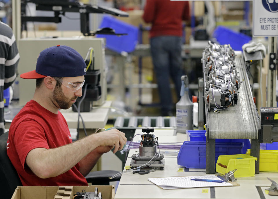 In this April 15, 2014 photo, Anthony Zingale wires blender motors at the Vitamix manufacturing facility in Strongsville, Ohio. A measure of the U.S. economy's health rose in March for the third consecutive month, a sign of stronger growth after harsh winter weather caused the economy's pace to slow. (AP Photo/Mark Duncan)