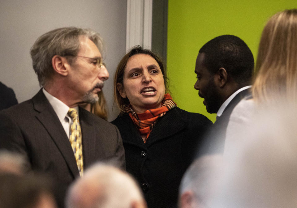 FILE - In this Feb. 5, 2020 file photo, a protester is escorted out of a campaign event after interrupting Democratic presidential candidate and former New York City Mayor Mike Bloomberg as he speaks in Providence, R.I. The far-reaching tentacles of Bloomberg's influence were on display at the event when Gov. Gina Raimondo became the first governor to endorse Bloomberg's candidacy. The room was packed with several of the state's influential Democrats, people wearing red Moms Demand Action shirts, as well as a handful of protesters angry about Bloomberg's record, including stop and frisk. (AP Photo/David Goldman, File)