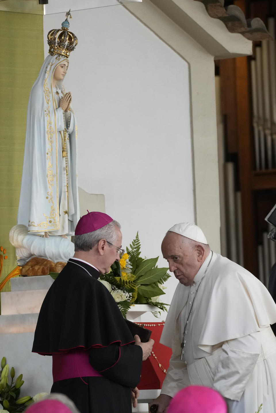 Pope Francis, right, arrives at the Catholic holy shrine of Fatima, in central Portugal, to pray the rosary with sick young people, Saturday, Aug. 5, 2023. Francis is in Portugal through the weekend to preside over the 37th World Youth Day, a jamboree that St. John Paul II launched in the 1980s to encourage young Catholics in their faith. (AP Photo/Gregorio Borgia)