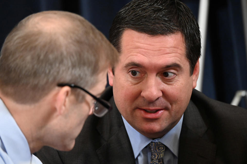 Rep. Jim Jordan, R-Ohio, speaks with Devin Nunes, R-Calif., during a break in an impeachment hearing on Capitol Hill, Dec. 9, 2019. (Erin Scott/Reuters)