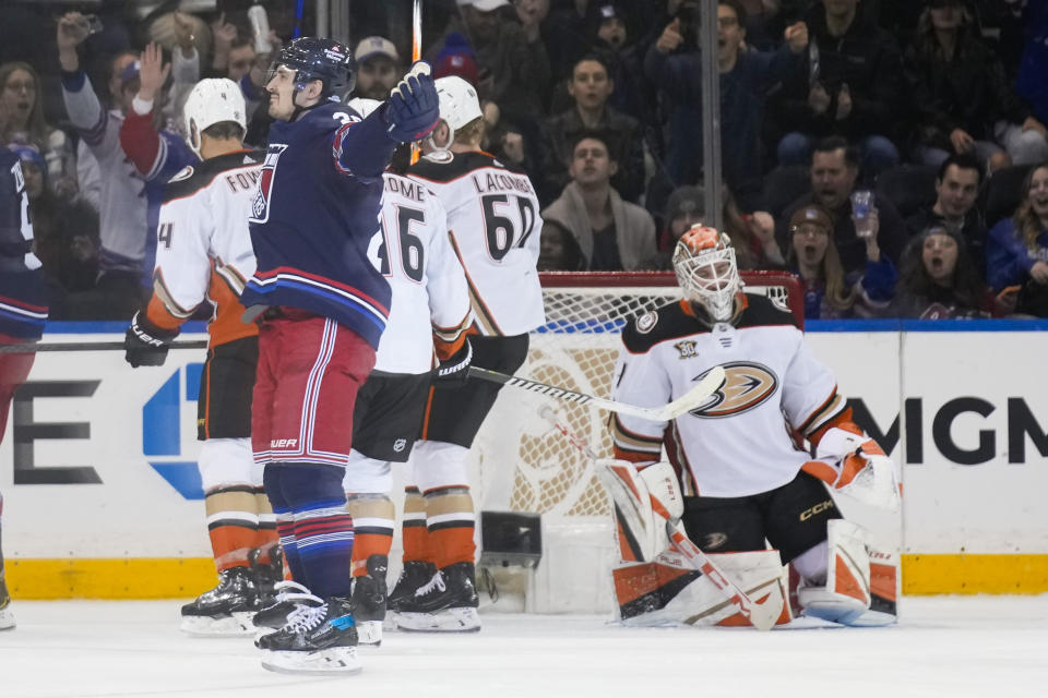 New York Rangers' Chris Kreider, front left, reacts after scoring on Anaheim Ducks goaltender Lukas Dostal, right, during the first period of an NHL hockey game Friday, Dec. 15, 2023, in New York. (AP Photo/Seth Wenig)