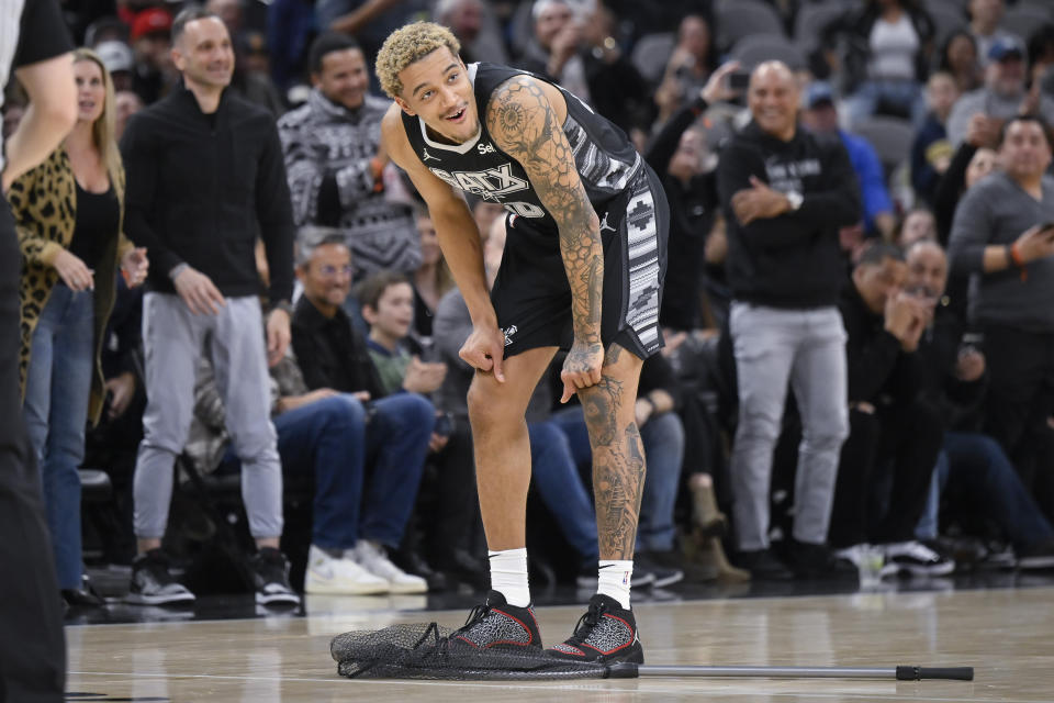 San Antonio Spurs' Jeremy Sochan reacts after looking at a bat that was caught in a net during the first half of the team's NBA basketball game against the Minnesota Timberwolves, Saturday, Jan. 27, 2024, in San Antonio. (AP Photo/Darren Abate)