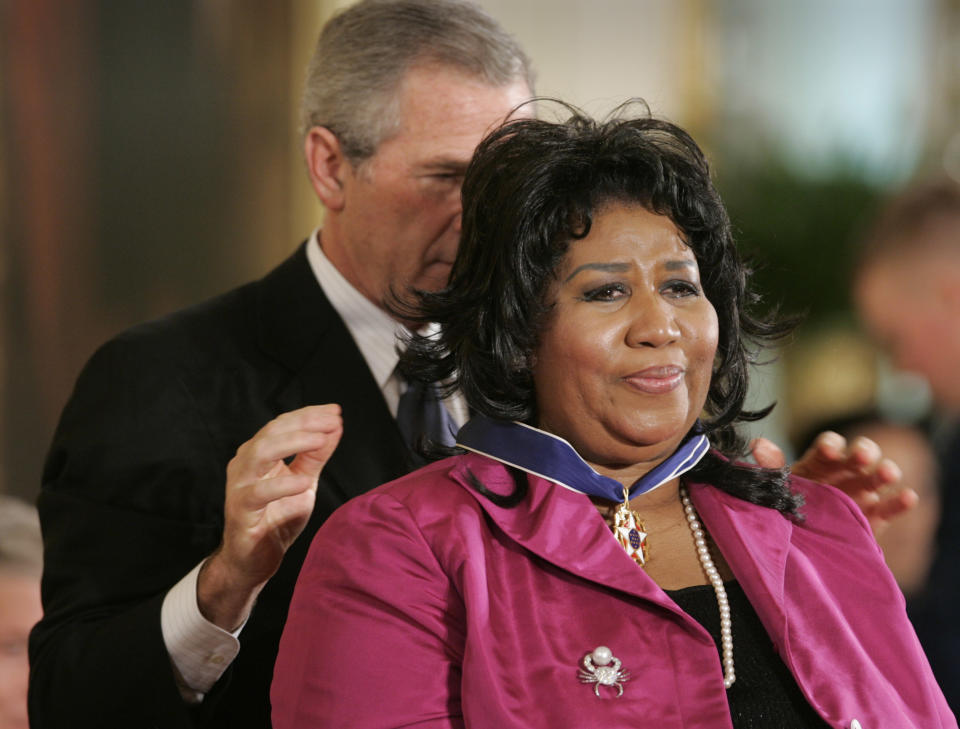 FILE - In this Nov. 9, 2005 file photo, President George W. Bush awards singer Aretha Franklin the Presidential Medal of Freedom Award, the highest civilian award, in the East Room of the White House in Washington. Franklin died Thursday, Aug. 16, 2018, at her home in Detroit. She was 76. Throughout Franklin's career, "The Queen of Soul" often returned to Washington - the nation's capital - for performances that at times put her in line with key moments of U.S. History. (AP Photo/Lawrence Jackson, File)