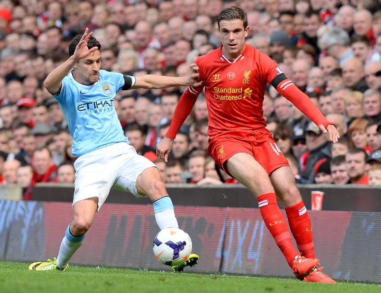 Manchester City's Jesus Navas (L) and Liverpool's Jordan Henderson during their Premier League match at Anfield on April 13, 2014