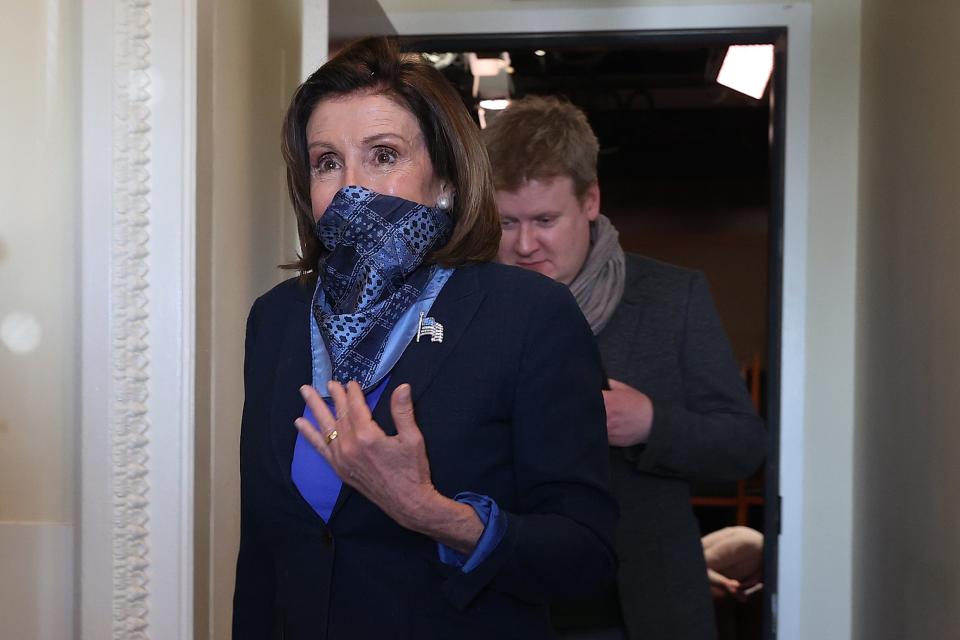House Speaker Nancy Pelosi (D-CA) wears a scarf over her mouth and nose as she and and her Deputy Chief of Staff Drew Hammill leave a news conference with Minority Leader Charles Schumer (D-NY) at the U.S. Capitol April 21, 2020 in Washington, DC.