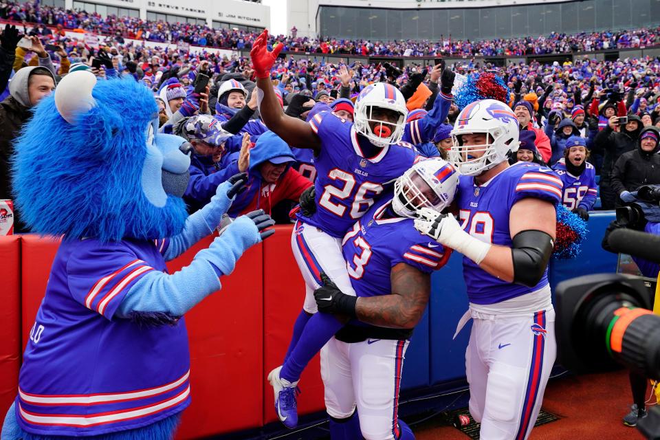 Nov 13, 2022; Orchard Park, New York, USA; Buffalo Bills offensive tackle Dion Dawkins (73) lifts Buffalo Bills running back Devin Singletary (26) to celebrate his touchdown against the Minnesota Vikings during the first half at Highmark Stadium. Mandatory Credit: Gregory Fisher-USA TODAY Sports