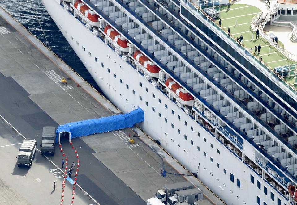 Passengers disembarking from the Diamond Princess cruise ship docked at Yokohama Port are pictured in Yokohama (REUTERS/Kyodo Japan)