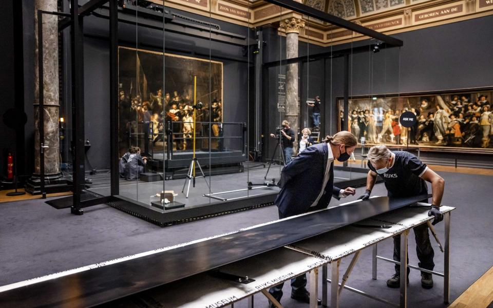 Museum workers check panels of reconstructed Rembrandt's masterpiece 'The Night Watch' before assembly in the Rijksmuseum - REMKO DE WAAL/EPA-EFE/Shutterstock 