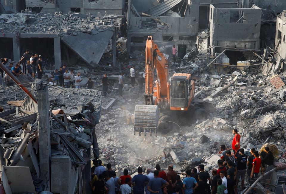 Palestinians search for casualties at the site of Israeli strikes on houses, in Khan Younis (REUTERS)
