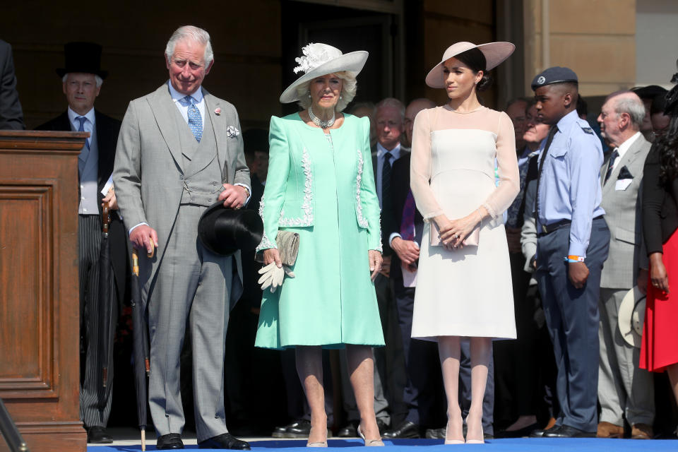 The Duchess of Sussex with Prince Charles and Camilla, the Duchess of Cornwall. (Photo: Getty Images)