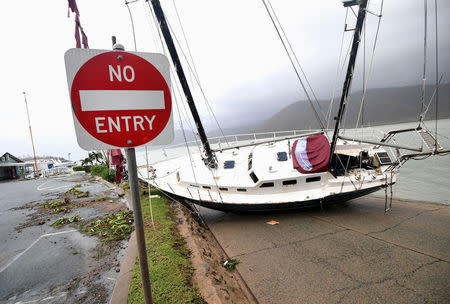 A boat is seen smashed against the bank at Shute Harbour, Airlie Beach, Wednesday, March 29, 2017. Cyclone Debbie has hit Queensland's far north coast yesterday as a category 4 cyclone, causing wide spread damage. AAP/Dan Peled/via REUTERS