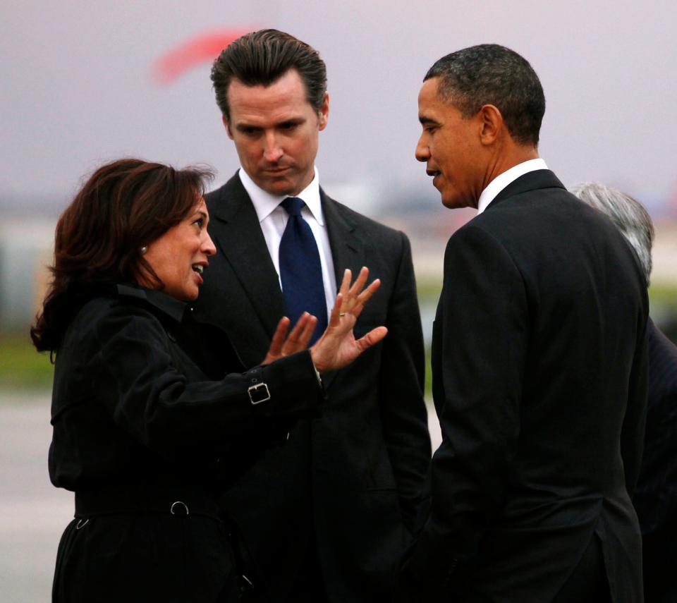 U.S. President Barack Obama is greeted by California Attorney General Kamala Harris and California Lt. Gov. Gavin Newsom upon his arrival in San Francisco February 17, 2011.